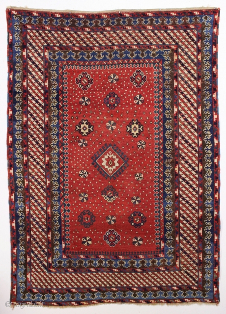 Antique large kazak with a dazzling field of tiny ivory stars. The spacious field framed with an unusual eye catching striped border and a matching pair of archaic trefoill minors. All beautiful  ...