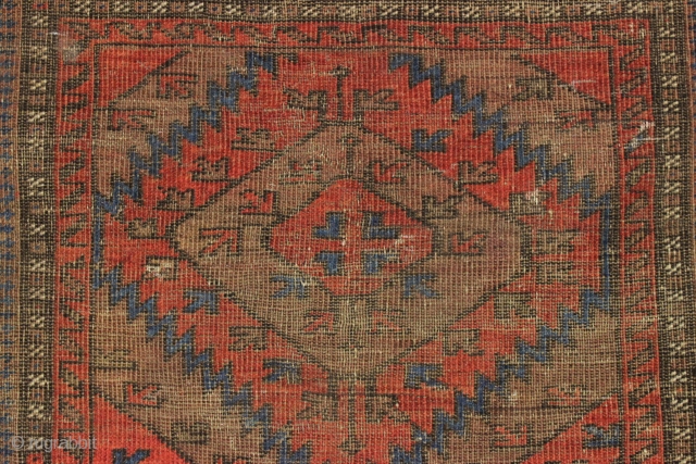 Antique baluch. Interesting large scale design. Nice reds. If wear is age then this one is ancient. Many many tiny moth nibbles and tiny holes, and hard to tell the front from  ...