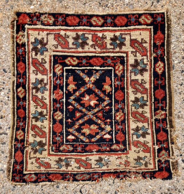 Early northwest Persian bagface. Unusual field design paired with a nice “star and bar” ivory border. Not for the condition conscious, very rough with numerous old small moth holes and nibbles. Original  ...