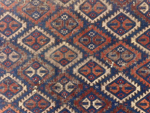 Antique Baluch rug with an uncommon “c gul” field. Acquired many years ago from a well known Providence collector. Not in great condition, holes and wear, but has presence. 19th c. 43”  ...