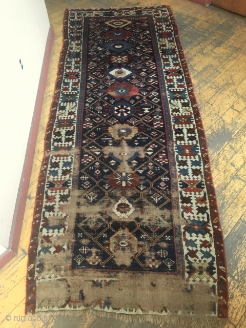 Antique long rug, possibly northwest Persian. Good quality rug in somewhat abused condition. Interesting field design and well drawn large scale  crab border. All natural colors. Large areas of wear, few  ...