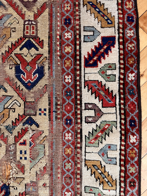 Early Caucasian long rug with a rich yellow ground and floral palmette lattice. Probably described as “gendge” for lack of a better name. Intact but with some heavy wear and exposed foundation.  ...