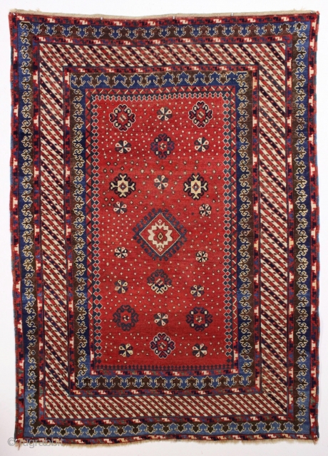 Antique large kazak with tiny stars, or are they snowfakes? The spacious field framed with an unusual eye catching striped border and a matching pair of terrific trefoill minors. All beautiful natural  ...