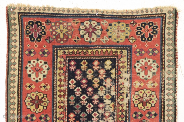 Antique caucasian rug. Early example in abused condition. An interesting design with all natural colors (no fuchsine). Grandma worked overtime flat stitching this beauty, filling in substantial sections by candlelight no doubt.  ...