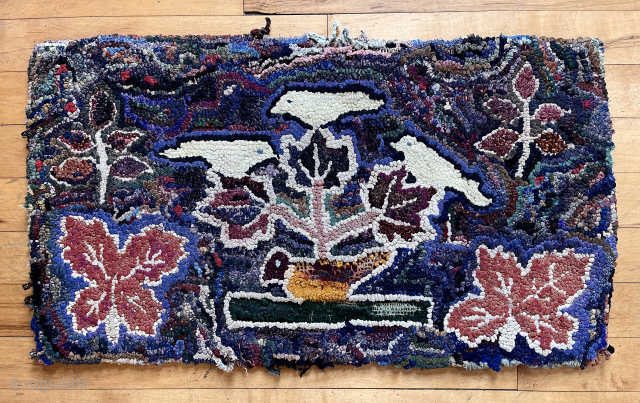 Early small American hooked rug. Original attractive design. Thick heavy construction, fabric backed. As found locally, some edge unraveling and wear. 19th c. 
20” x 36”  waynecbarron@aol.com     