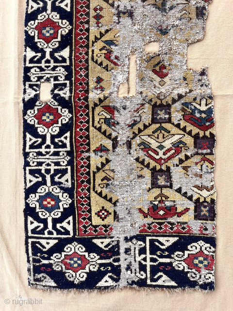 Out of the cedar chests. Early yellow ground Caucasian rug fragment. Sewn onto backing cloth. Saturated colors. Fine Kufic border. Good age. First half 19th c. Largest section 18” x 43”  