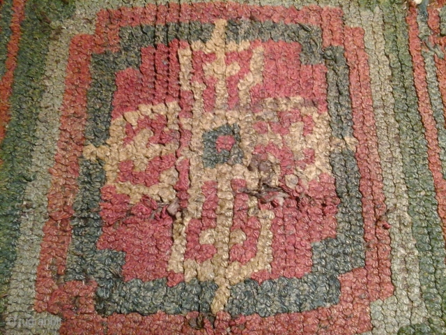 Tibetan 'warp face back' rug-fragment from monastic origins with a pure crossed Vajra symbol. An ancient piece that requires delicate handling, acquired in China. Fragment's size: 75x50 cm.     