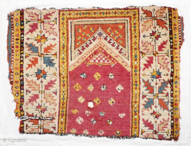 Fragment turkish prayer rug, 90x70 cm. Mid 19th.c. w/w. This Manastir-fragment has historical relevance,not because it still has a full pile,but because of it's colors,no longer from our world.Mounted on linen.
  