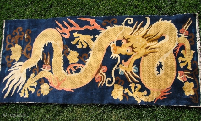 Chinese dragon rug (#857) 3’ 7” x 8’ 1”; large gold dragon in clouds on indigo field, excellent condition, 20th century.            