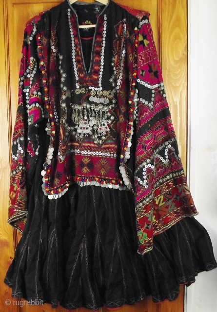 Exceptionally fine Kohistani dress called a jumlo, decorated with silk embroidery, mother of pearl buttons silver coins and amulets. Please email for more information or to arrange a viewing.
    