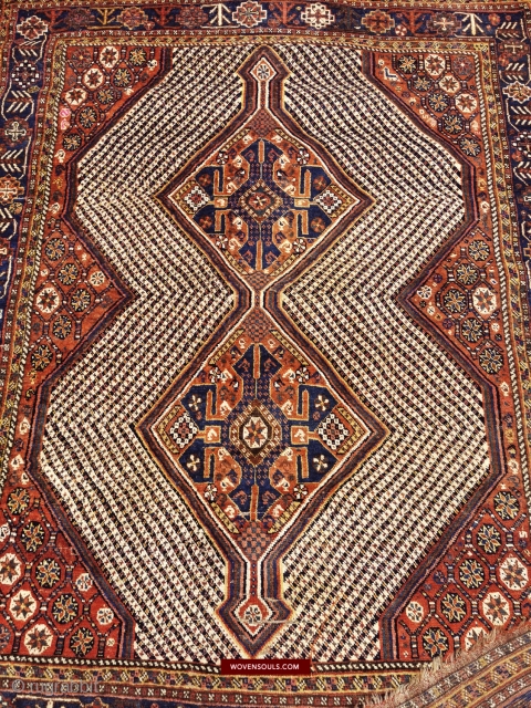 Village Nieriz South Persian Fishbone rug with stunning star lattice in the four corners separated by candy-stripes. One corner has an animal strolling amidst the flowers. Discounted for a limited time. Shipping  ...