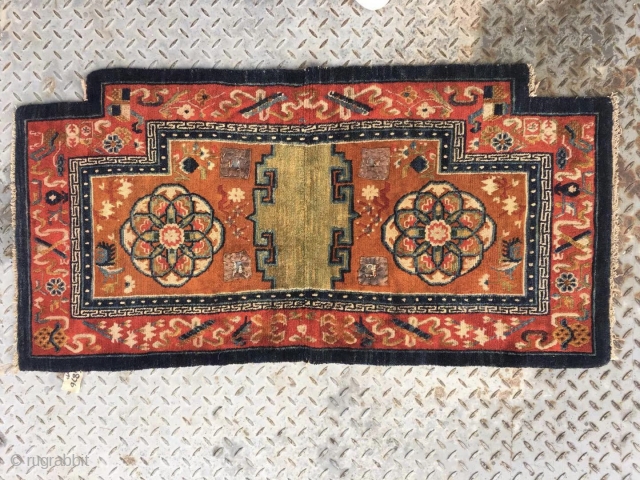 Tibetan  horse saddle rug, Orange background color with group flower pattern, Chinese traditional eight treasures selvage. Good age and condition. Size 65*138cm (25*54”)
         