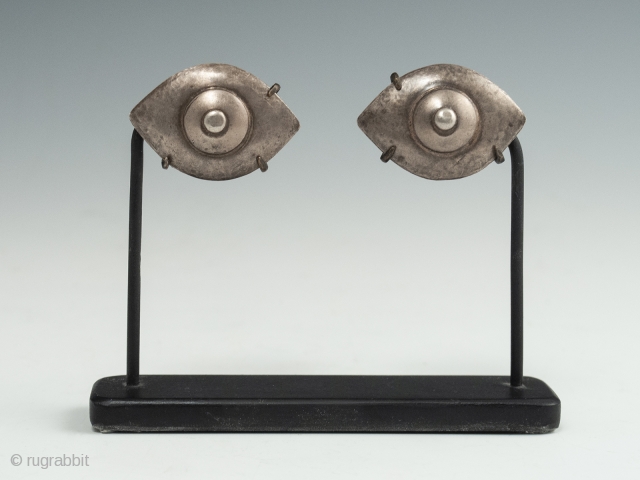 Silver eyes, China or India. 1.25" (3.2 cm) wide each, 2.75" (7 cm) high, as based
Late 19th to early 20th century. Ex. Cathryn Cootner, Sonoma. These mesmerizing inlaid eyes once likely adorned  ...