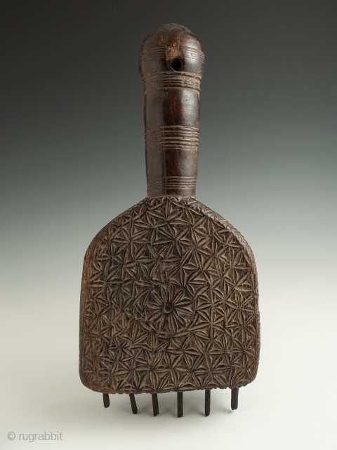 Large weaving comb from Anatolia, Turkey, in carved wood and with iron tines. 12.5" (31.7 cm) high by 5.75" (14.6 cm) wide, early 20th century. Ex. Cathryn Cootner, Sonoma.    