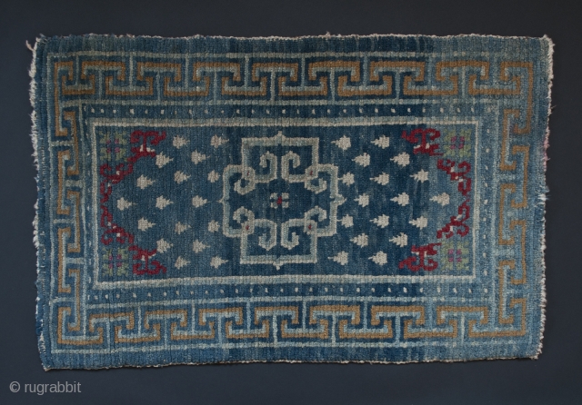 Small wool rug, Tibet. 22" (56 cm) by 35" (89 cm).
Please note: the second images of the full rug and the detail are photos of the back of the rug. They look  ...