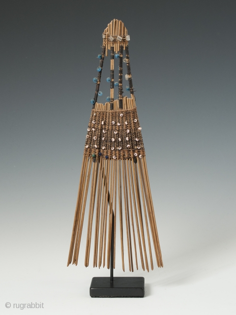 Comb (helu), Tonga. Coconut palm leaf, plant fibre, fine wire, seed beads. Mid-20th century. 7.5" (19 cm) high. Combs like this were indicative of rank and worn in the hair as ornamentation,  ...