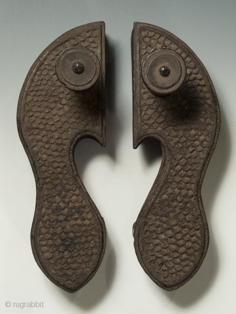 Khadau chappals or paduka, India, Wood, 10" (25.3 cm) long, Late 19th to early 20th century.

A heavily encrusted pair of Indian paduka sandals with a simple scale pattern. Because leather was prohibited  ...