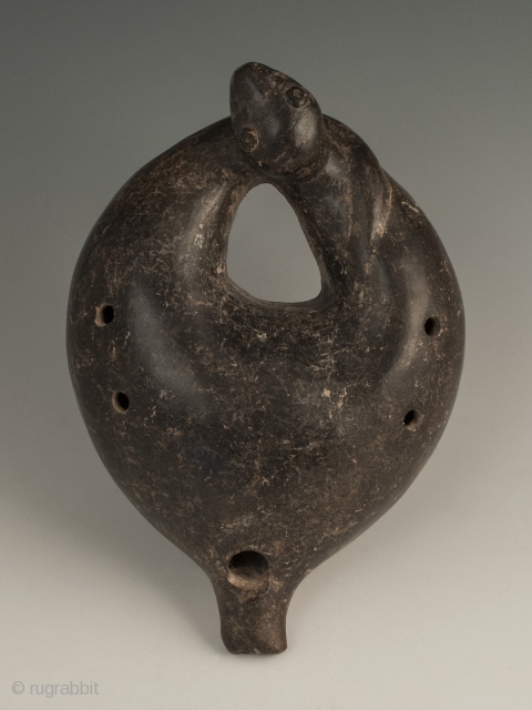 Ocarina in the shape of a serpent, Colima, West Mexico, Terracotta, Ca. 100 B.C. to 250 A.D., 6.5" (16.5 cm) long by 4.5" (11.4 cm) wide. Ocarina in a curled serpent form  ...
