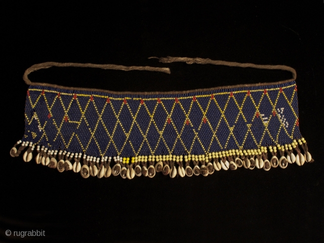 Pikuran (cache-sex), Kirdi people, Cameroon.
Seed beads, cotton string, cowrie shells.
21" (53 cm) wide by 6.5" (16.5 cm) high.
Mid 20th century.
#1645             