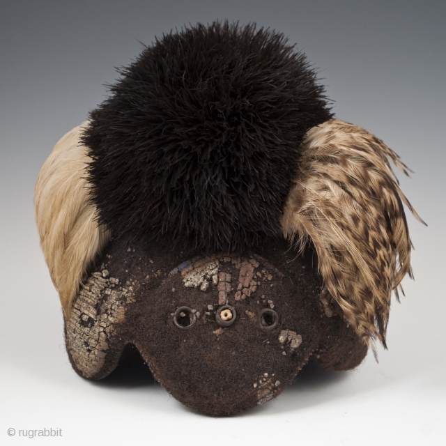 Emedot Headdress,
Karamojong tribe, Uganda/Kenya.
Feathers, felted human hair, clay, wire, aluminum rings,
20th century.
8.5" (21.6 cm) high by 7.5" (19 cm) wide by 6.5" 16.5 cm) deep
Ex. Merton D. Simpson
Catalog notes: "Amoung a selection  ...