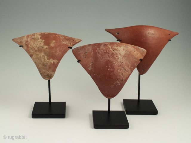 Three redware tangas, Marajoara culture, Marajo Island, Para, Brazil. 6.25 to 7 inches wide (15.8 to 17.7 cm), Ca. 500-1400 A.D.. Ex Jean-Eugene Lyons collection, Geneve, Switzerland. Tangas are thin concave triangular  ...