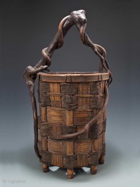 Ikebana basket,
Japan.
Split bamboo, mulberry bark, twisted branch and vine.
Showa Period,
20.5" (52 cm) high by 11" (28 cm) wide               