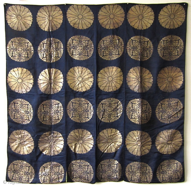 Japanese Antique Large Buddhist Textile Cover

Beautiful antique Japanese large covering originally used in a Buddhist temple. Three deep blue silk panels sewn together and woven with gold in design of 18 chrysanthemums  ...