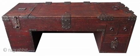 Rare Japanese Low Shop Desk Tansu

Unusual Japanese hardwood low shop desk tansu. Original red lacquer finish with heavy iron plates and mounts. The table surface is hinged with three doors that open  ...