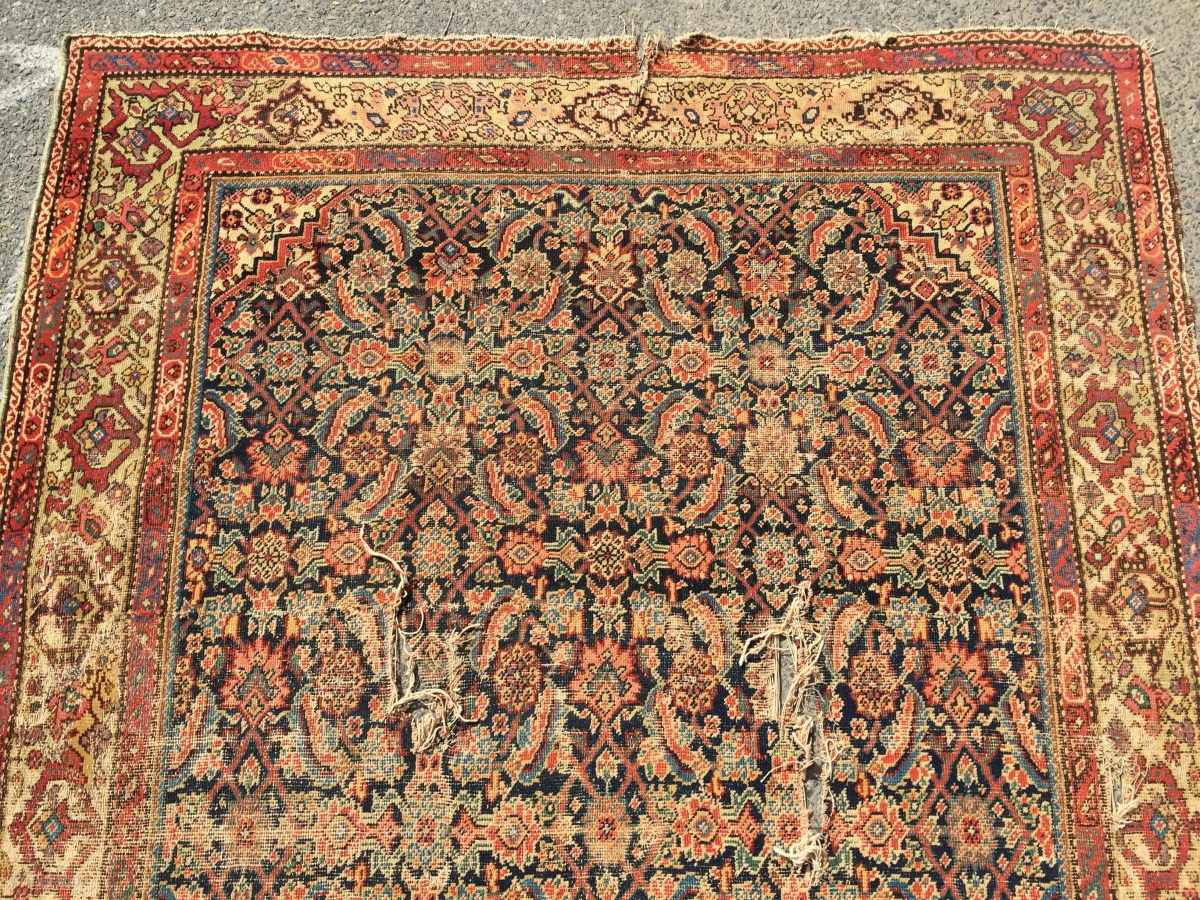 What remains of a genuine antique Persian ferrahan rug. Thin with ...