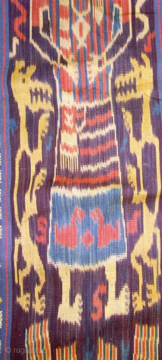 A beautiful example of Sumba Hinggi with 2 techniques, Ikat and traditional.   Mystical figures 4 bold human figures with mysterious designs on their chests and body, two on each woven  ...