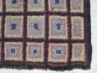 American hooked rug, hand hooked on burlap, c.1930, very arts and crafts, 32 squares on a black background, blue, gray, lavender, light green, and red outlining in each square,  general good  ...