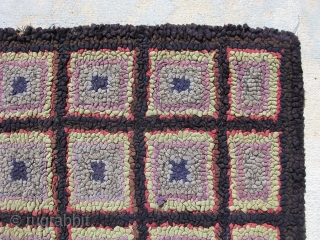 American hooked rug, hand hooked on burlap, c.1930, very arts and crafts, 32 squares on a black background, blue, gray, lavender, light green, and red outlining in each square,  general good  ...
