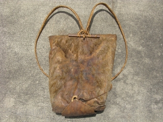 Old backpack made by one of the former head hunter tribes of Northern Luzon, Philippines, Ifugao People (attributed), a partial animal hide with the stubby ends of the hind legs still attached,  ...