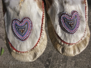 Antique Inupiat moccasins, also Inupiaq, a people of Northern Alaska, part of the Inuit Peoples, hand sewn with beaded hearts, 1st QTR 20thC, used with signs of use and soiling, the approximate  ...