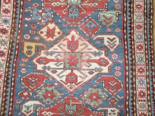 Pleasant Kazak. Good range of colours. Abrash. Interesting design. Slight losses one end, wear in the field in places and sides secured. But still bright and decorative. 199 by 100cm   