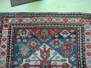 Pleasant Kazak. Good range of colours. Abrash. Interesting design. Slight losses one end, wear in the field in places and sides secured. But still bright and decorative. 199 by 100cm   