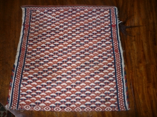 Sweet little Turkoman bag in white goat hair. All over motifs on front and back in red, rust and indigo. The second photo is the reverse. 36cm square. Couple of small repairs  ...