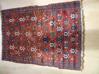 Pretty little 19th century kazak. Great colours and design. Losses to sides and edges. Couple of patches at back where rug is worn. Size 47 inches by 34.     