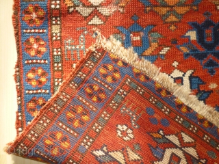 Pretty little 19th century kazak. Great colours and design. Losses to sides and edges. Couple of patches at back where rug is worn. Size 47 inches by 34.     