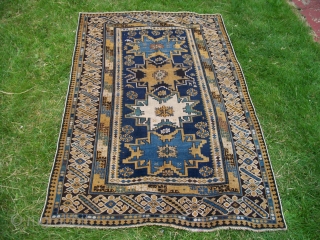 An unusual Lesghi rug with Chichi borders. Circa 1900, size 6'x3'10" [117cm x 183cm]. All wool. Excellent condition, original sides, and a nice floppy handle. 
       