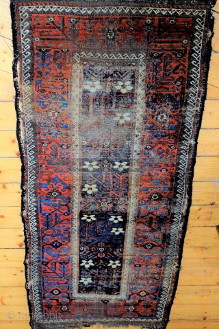 An early Mina Khani Persian Baluch Rug 
Size 215 x 91 cm
In distressed fragmented condition with wonderful colours, including an electric blue and aubergine brown and dating from the mid 19th century.  ...