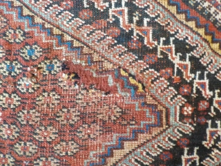 Attractive antique Khamseh with vibrant colours. Partially low pile and a small area with a reparation and a very small hole (see last two photos). Size is 220 x 153 cm.  