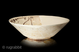 Fragment of a Large Samarkand Bowl, of conical form with steep flaring walls, stepped down to a low foot, slip-painted, decorated in brown on a slip ground with a single band of  ...