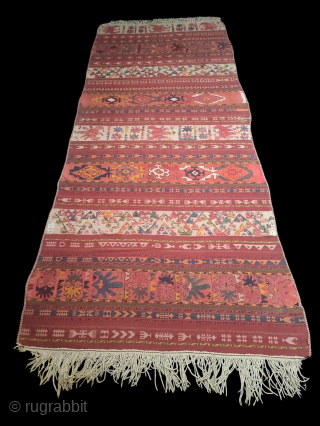 Uzbek Kilim, Central Asia, 1920s, 317 x 130 cm, wool, wool embroidery, narrow bands of plain weave over-embroidered with Central Asian motifs, in good condition, scattered loss of embroidery.    