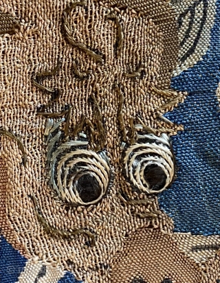 An eighteenth century Chinese silk, slit tapestry weave in silk and metal thread. Eyes and some facial details embroidered in silk(detail) 15 X 12 inches.        