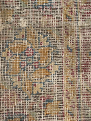 Indian Deccani carpet fragment. Circa 1700? Design reminiscent of Mughal pieces. corroded lac ground and black border with characteristic mustard gold. Very worn / blitzed with a white cotton foundation shinning forth.  ...