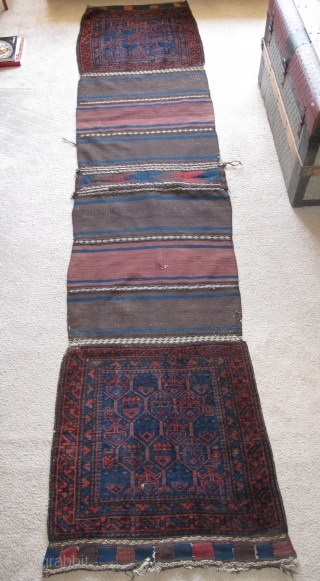 Complete Timuri type Baluch Khorjin Saddle Bag Set. The sides have been opened but the entire piece is complete and in great shape with both bagfaces, flat-woven fasteners and kilim bridge. Super  ...