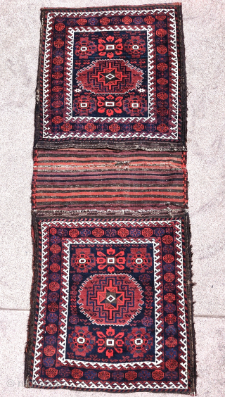 Complete Baluch khorjin with a very unusual design integrating minakhani flowers with a central Memling medallion. All good colors and in good condition. Probably Torbat-i Jam, circa 1880.  Very rare and  ...