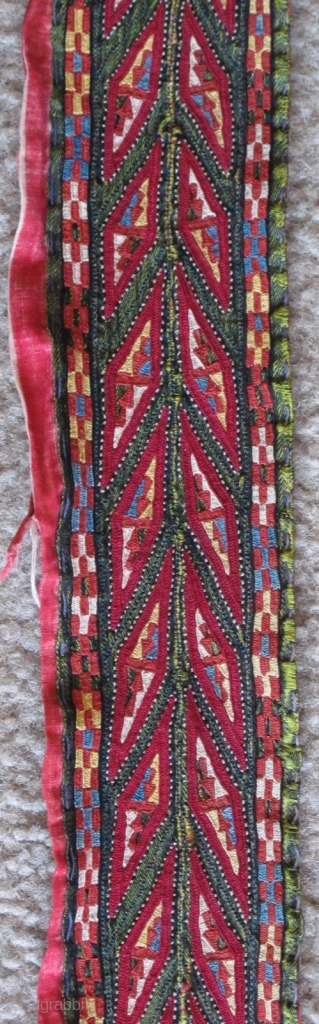 Tekke Turkmen embroidered band. Very fine. Very colorful with several blues, yellow, orange and insect red. Embroidered on a hand-woven green silk. 105x6cm          