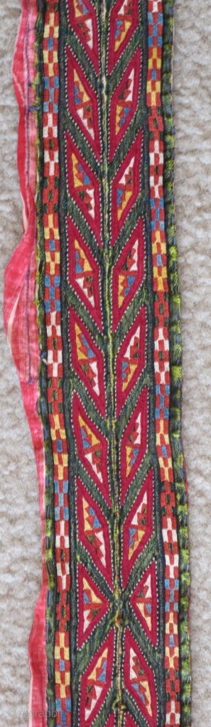 Tekke Turkmen embroidered band. Very fine. Very colorful with several blues, yellow, orange and insect red. Embroidered on a hand-woven green silk. 105x6cm          